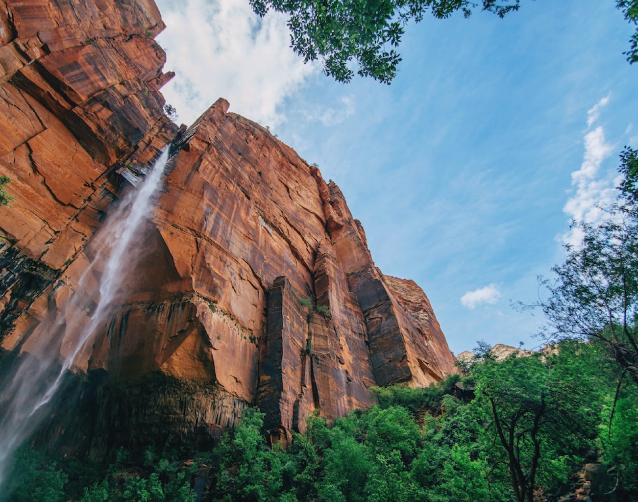 Dramatic waterfall cascading down red rock cliffs in the Horn of Africa landscape